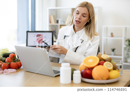 Caucasian doctor in white coat gives professional consultation remotely. 114746891