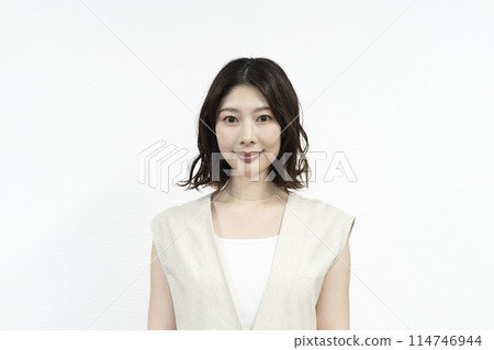 A woman in her thirties smiling at the camera A woman in her thirties smiling at the camera 114746944