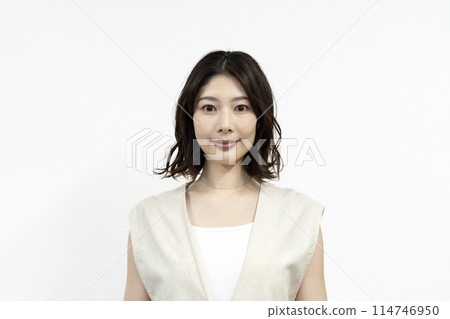 A woman in her thirties smiling at the camera A woman in her thirties smiling at the camera 114746950