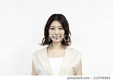 A woman in her thirties smiling at the camera 114746964