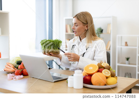 Smiling Caucasian woman introducing microgreens during online conversatio Smiling Caucasian woman introducing microgreens during online conversatio 114747088