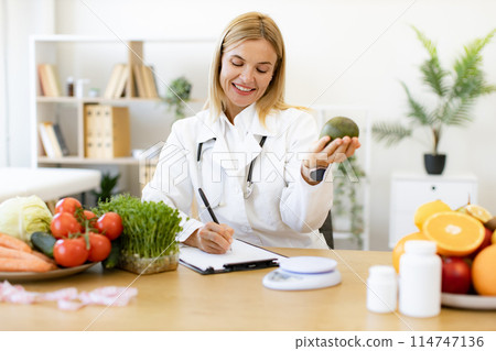 Happy female writing prescription for patients proper healthy diet. 114747136