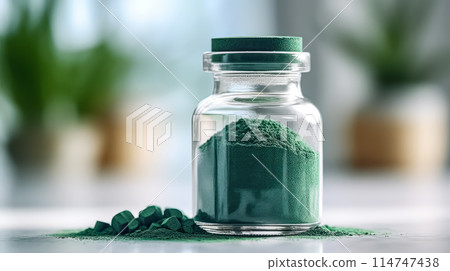 Spirulina powder in a glass jar on a wooden table 114747438