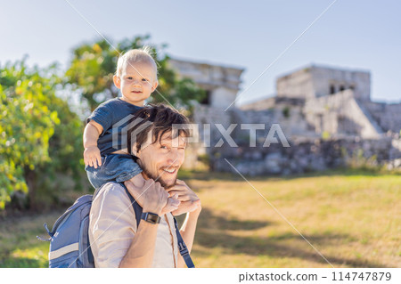 Father and son tourists enjoying the view Pre-Columbian Mayan walled city of Tulum, Quintana Roo, Mexico, North America, Tulum, Mexico. El Castillo - castle the Mayan city of Tulum main temple Father and son tourists enjoying the view Pre-Columbian Mayan walled city of Tulum, Quintana Roo, Mexico, North America, Tulum, Mexico. El Castillo - castle the Mayan city of Tulum main temple 114747879