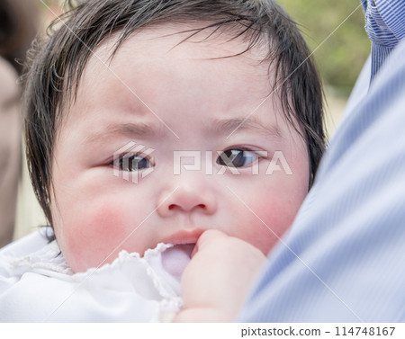 [Baby at shrine visit held by his father] 114748167