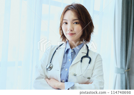 Female doctor standing by the window Female doctor standing by the window 114748698