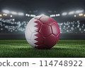 Soccer ball in flag colors on a bright blurred stadium background. Qatar. 3D image 114748922