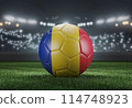 Soccer ball in flag colors on a bright blurred stadium background. Romania. 3D image 114748923