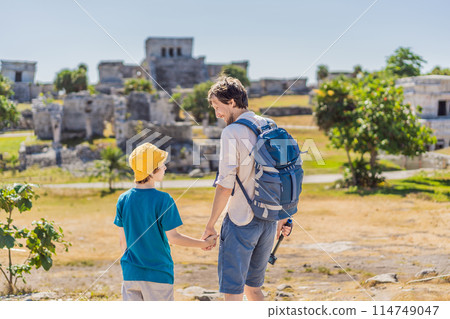 Father and son tourists enjoying the view Pre-Columbian Mayan walled city of Tulum, Quintana Roo, Mexico, North America, Tulum, Mexico. El Castillo - castle the Mayan city of Tulum main temple Father and son tourists enjoying the view Pre-Columbian Mayan walled city of Tulum, Quintana Roo, Mexico, North America, Tulum, Mexico. El Castillo - castle the Mayan city of Tulum main temple 114749047