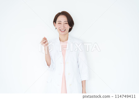A female doctor in a white coat doing a fist pump (white background) A female doctor in a white coat doing a fist pump (white background) 114749411