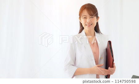 A middle woman with a smiling face in a white suit 114750598
