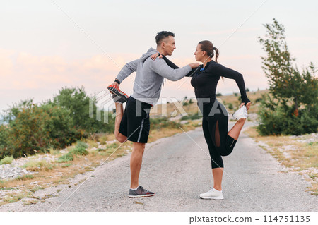 A Romantic Couple Stretching Down After a Run A Romantic Couple Stretching Down After a Run 114751135