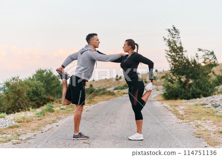 A Romantic Couple Stretching Down After a Run 114751136