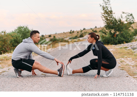 A Romantic Couple Stretching Down After a Run A Romantic Couple Stretching Down After a Run 114751138