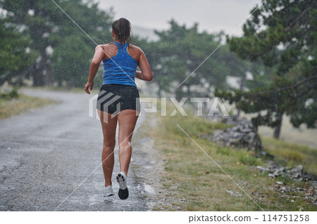 Unstoppable: A Determined Athlete Trains Through the Rain in Pursuit of Marathon Glory 114751258