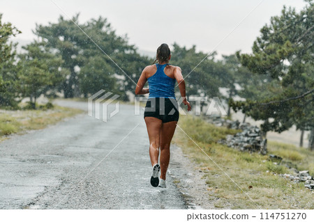 Unstoppable: A Determined Athlete Trains Through the Rain in Pursuit of Marathon Glory 114751270
