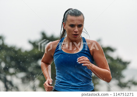 Unstoppable: A Determined Athlete Trains Through the Rain in Pursuit of Marathon Glory 114751271