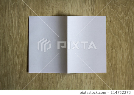 Blank white piece of paper on wooden background Blank white piece of paper on wooden background 114752273
