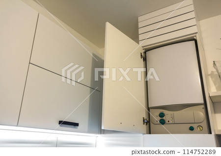 Home gas water heater boiler in kitchen furniture for apartment of home heating. Home gas water heater boiler in kitchen furniture for apartment of home heating. 114752289