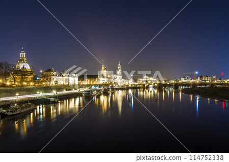 Night cityscape view of historic buildings with reflections in Elbe river in the center of Dresden (Germany). 114752338