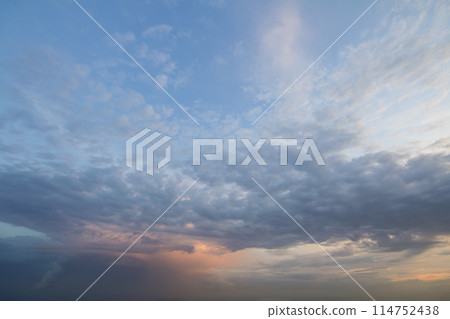 Panorama of sky at sunrise or sunset. Beautiful view of dark blue clouds lit by bright orange yellow sun on clear sky. Beauty and power of nature, meteorology and climate changing concept. Panorama of sky at sunrise or sunset. Beautiful view of dark blue clouds lit by bright orange yellow sun on clear sky. Beauty and power of nature, meteorology and climate changing concept. 114752438