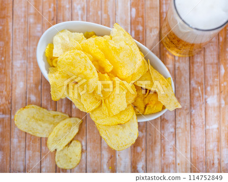 Potato chips served with glass of beer 114752849