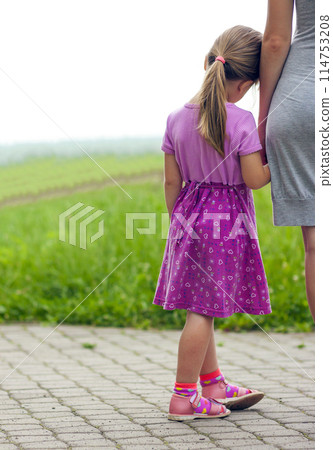 Little girl holding a hand of her mother. Family relations conce Little girl holding a hand of her mother. Family relations conce 114753208