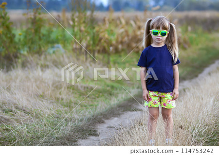 Portrait of little fashionable girl in green sunglasses outdoors Portrait of little fashionable girl in green sunglasses outdoors 114753242