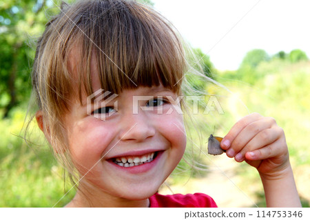 Little girl smile at the camera. Portrait of happy, positive, smiling, playful caucasian girl with butterfly in her hand Little girl smile at the camera. Portrait of happy, positive, smiling, playful caucasian girl with butterfly in her hand 114753346