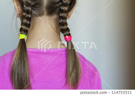 Close up rear- vew portrait of a cute little girl with funny pigtails on white background. Fashion and happy childhood. Close up rear- vew portrait of a cute little girl with funny pigtails on white background. Fashion and happy childhood. 114753551