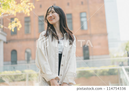 A young woman walking alone in the city on a holiday A young woman walking alone in the city on a holiday 114754336