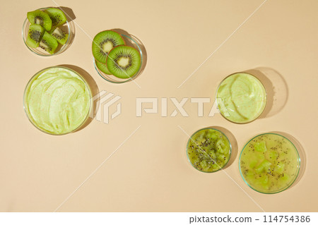 The yellow flat containing some petri dishes in different sizes above, blank space in center for displaying exfoliating product has origin. High angle shot advertising photo 114754386