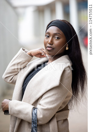 Chic Urban Confidence: Young Black Woman in Elegant Fall Attire Chic Urban Confidence: Young Black Woman in Elegant Fall Attire 114755011