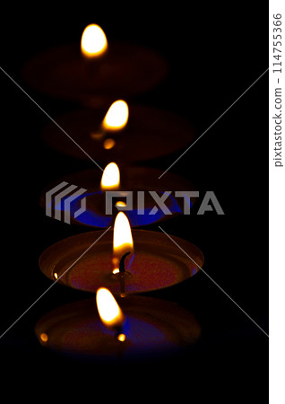 Candle light on black background. Shallow depth of field. Vertical photo Candle light on black background. Shallow depth of field. Vertical photo 114755366