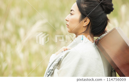 A woman walking in pampas grass 114756009