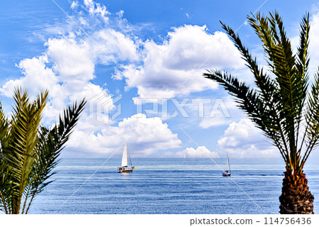 Spectacular image with calm sea and sailboat in the background on Aguadulce beach, Almeria, Spain 114756436
