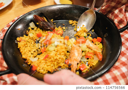 Eating paella Eating paella 114756566