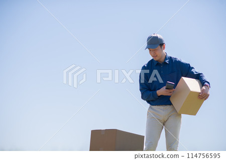 Delivery person checking the package 114756595