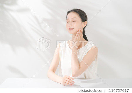 A woman who feels moisturized skin A woman who feels moisturized skin 114757617