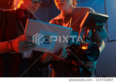 Cropped shot of video production crew discussing images on digital tablet screen copy space Cropped shot of video production crew discussing images on digital tablet screen copy space 114758897