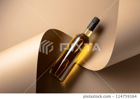 Bottle of white wine on a beige background. 114759164