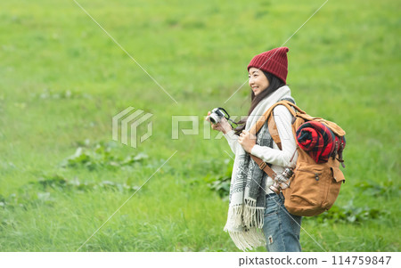 A woman holding a camera A woman holding a camera 114759847