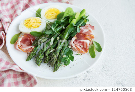 Fresh Asparagus and Prosciutto Salad Served With Boiled Eggs and Microgreens Fresh Asparagus and Prosciutto Salad Served With Boiled Eggs and Microgreens 114760568