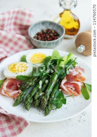 Fresh Asparagus and Prosciutto Salad Served With Boiled Eggs and Microgreens Fresh Asparagus and Prosciutto Salad Served With Boiled Eggs and Microgreens 114760570