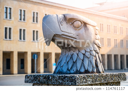 A detailed sculpture of an eagles head by Wilhelm Lemke, set against the backdrop of terminal building of Tempelhof Airport. Eagle Square, Berlin, Germany A detailed sculpture of an eagles head by Wilhelm Lemke, set against the backdrop of terminal building of Tempelhof Airport. Eagle Square, Berlin, Germany 114761117