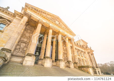 The Reichstag Building bathes in the warm glow of the setting sun, highlighting its neoclassical architecture. The seat of the German Bundestag, Berlin, Germany. 114761124