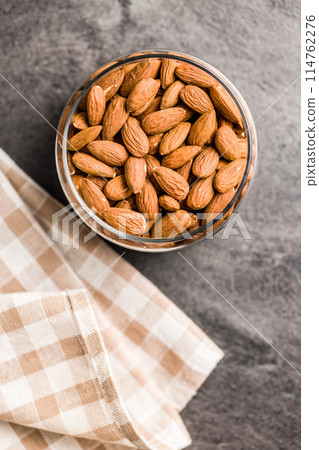 Peeled almond nuts in bowl, Top view. 114762276