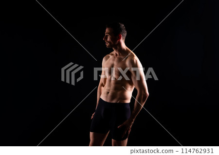 Portrait of man, bodybuilder and bicep flex in studio, background and exercise for muscular power. 114762931