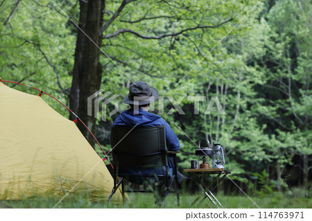A man enjoying solo camping 114763971