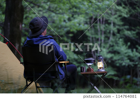 Man enjoying camping at sunset 114764081